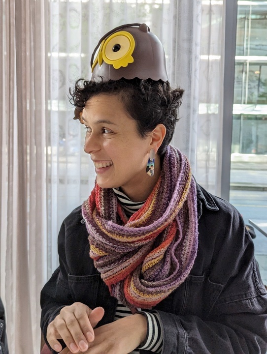 a Picture of Sophia Vargas smiling and wearing an owl hat.